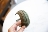 Ribbed texture and braided edge detail on the curved antique bronze African cuff.