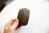 Faceted antique African bronze cuff bracelet, textured surface held by hand.