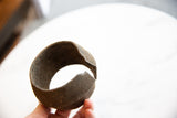 Antique African bronze alloy cuff bracelet revealing rich patina and textured opening edge.