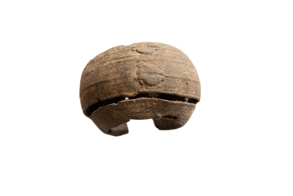 Antique African metal cuff bracelet with a wide, textured band and raised geometric details.
