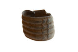Antique African bronze wide cuff bracelet with a rich patina and raised geometric detailing.