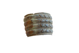 Antique African bronze wide cuff bracelet with horizontal bands, geometric motifs, and a rich patina.