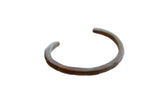 Antique African bronze and copper cuff bracelet with a diagonal barber pole design and aged patina.