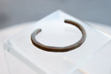 Side view of the antique African bracelet showing its distinct barber pole design.