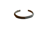 Antique handmade African bronze cuff bracelet with a rich patina and faded surface detailing.