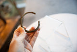 Side view of the antique African bronze cuff bracelet showing its scale and form.