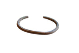 Antique African copper cuff bracelet with a minimal, open design and a rich, aged patina.