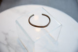 Collectible antique African copper cuff with a simple, open shape and dark aged patina.