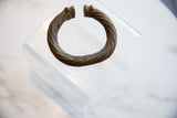 Twisted rope texture and dark aged patina on an antique African metal alloy bracelet.
