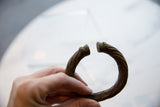 The unique craftsmanship of the open ends on an antique African metal bracelet.