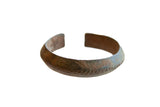 Antique African bronze alloy child's cuff bracelet with a dark, textured patina.