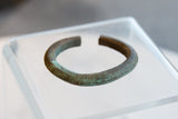 Profile view of the antique African copper cuff highlighting its C-shape and textured patina.