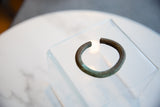 Angled view of the antique African copper cuff's circular form and rich, time-worn patina.