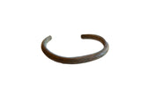 Antique African bronze striped cuff bracelet with a dark, time-softened patina.