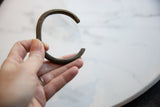 Handmade antique African bronze cuff bracelet showing its solid C-shaped profile.