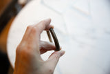 Hand-worked striped texture and rich patina on an antique African copper cuff.