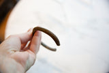 Antique African copper cuff showing its aged patina and hand-worked linear details.