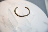Side profile of the antique African bronze cuff bracelet showing its open form and rich patina.
