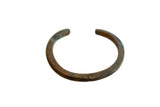 Antique African child's bronze cuff showing its simple handmade form and rich, aged patina.