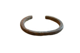 Antique African bronze cuff bracelet with a hand-forged texture and subtle geometric detailing.