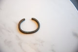 Simple open form of an antique African bronze bracelet with a rich, time-softened patina.