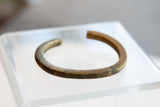 Faded etched details and rich patina on the antique bronze African cuff.