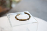 Angled view of the antique African bronze cuff, highlighting its aged, textured surface.