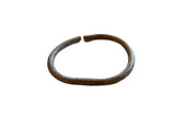 Antique African bronze cuff bracelet with a dark patina and faded surface detailing.