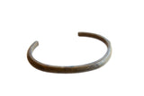 Antique African bronze cuff bracelet with a simple, rounded form and an aged patina.