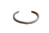 Antique simplistic African aluminum cuff bracelet with a weathered, time-worn patina.