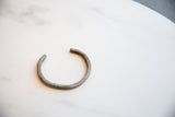 Collectible African cuff bracelet showing its simple, rustic, aged form.