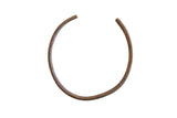 Vintage African bronze artifact in an open circle shape with hand-etched geometric detailing.