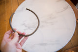 The curved, open form of the vintage bronze artifact showing its handmade geometric texture.