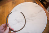 Vintage African bronze artifact held to display its curved shape and scale.