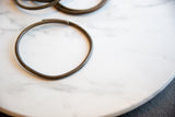 A single vintage African bronze ring showing its dark, smooth patina.