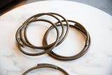 Close-up of vintage African bronze rings showcasing their aged texture and dark patina.