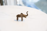 Rear profile of the vintage handmade bronze elephant highlighting its large ears and body.