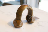 Angled view of the vintage African cuff showing its hand-etched geometric details and warm patina.