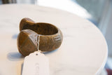 Vintage African cuff bracelet displaying handcrafted geometric etchings and a warm, oxidized patina.