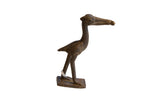 Vintage African dark bronze stork sculpture holding a fish, with a textured, handmade finish.