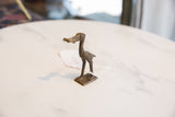 Side profile of the vintage dark bronze stork, showing its handmade texture and form.