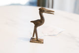 Side view of the vintage bronze stork highlighting its textured, handmade details.