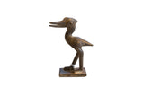 Vintage handmade African stork sculpture in dark bronze with its head turned.