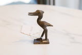 Side profile of the vintage African bronze stork showing its hand-cast texture.