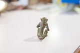 Vintage African bronze monkey sculpture, back view with textured green patina.