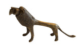 Vintage African bronze lion figurine with a textured surface and stylized, elongated shape.