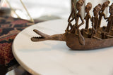 Close-up of artisanal bronze Dogon ancestor figures, handcrafted with lost wax casting texture.