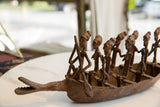 Collector's antique African bronze boat showing detailed figures and crocodile head.