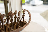 Textured bronze figures inside the antique African lost wax cast boat.