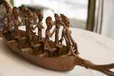 Blurred close-up of the antique African bronze crocodile head, showing its aged patina.